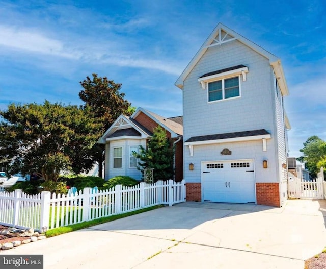 10434 New Quay Rd, Ocean City, MD 21842 - view of front of property featuring brick siding, a garage, concrete driveway, and a fenced front yard