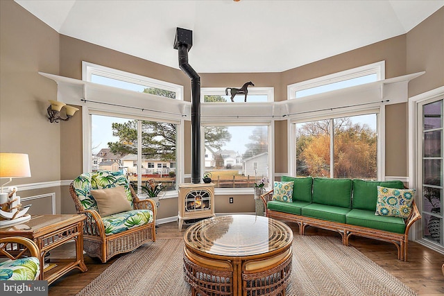 sunroom with a healthy amount of sunlight and a wood stove