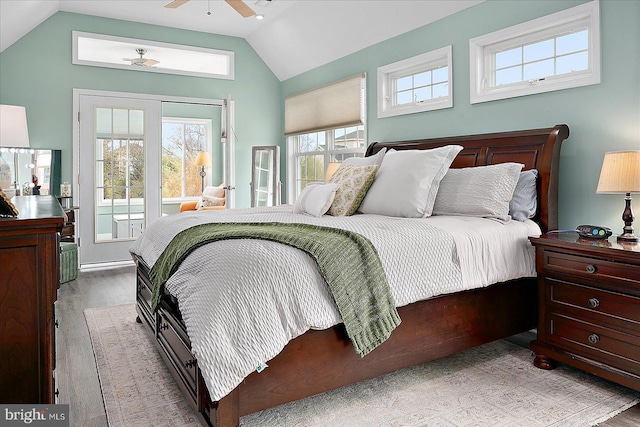 bedroom featuring vaulted ceiling, access to outside, and light hardwood / wood-style floors