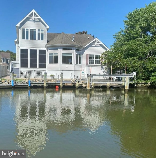 rear view of property featuring a water view