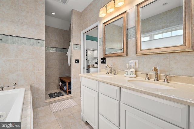 bathroom featuring vanity, shower with separate bathtub, tile patterned flooring, and tile walls