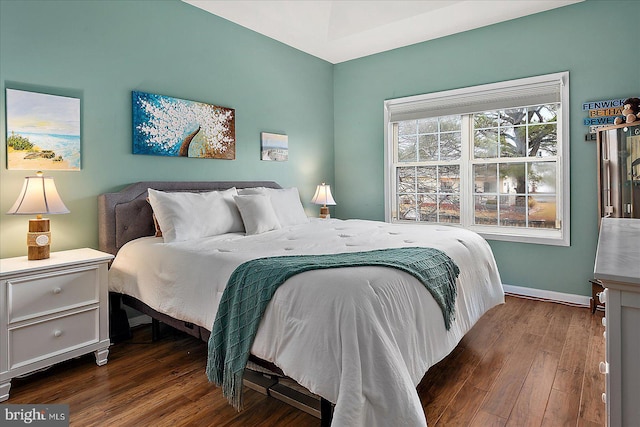 bedroom with dark hardwood / wood-style flooring