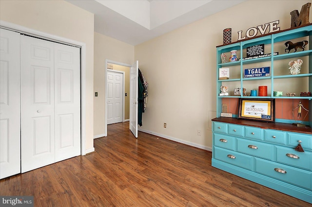 unfurnished bedroom featuring dark hardwood / wood-style floors and a closet