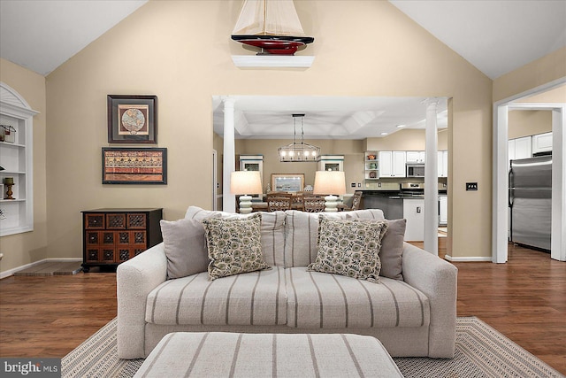 living room featuring high vaulted ceiling, decorative columns, and dark hardwood / wood-style floors