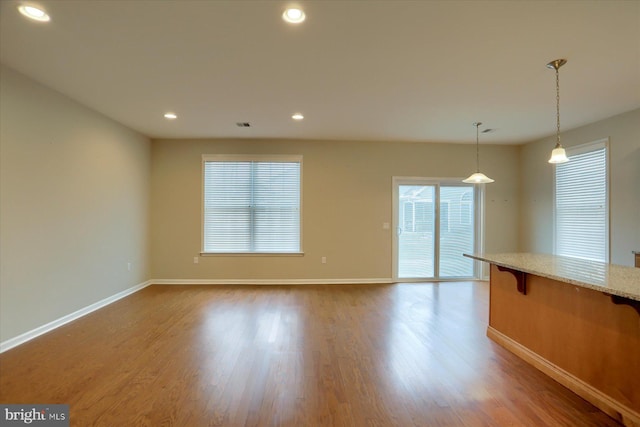 unfurnished living room featuring hardwood / wood-style floors