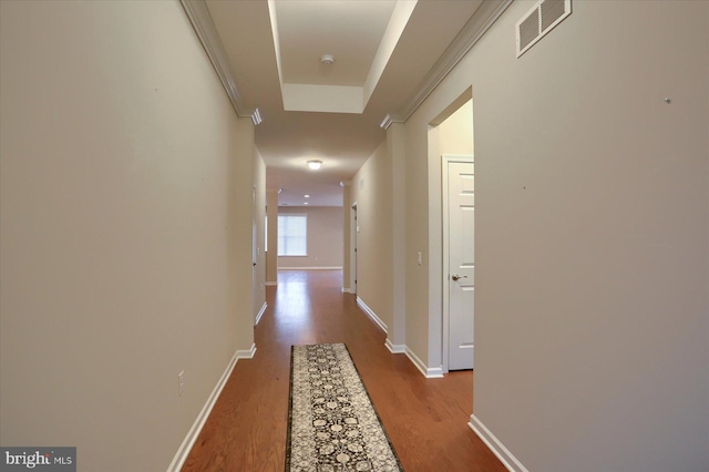 corridor featuring ornamental molding and light hardwood / wood-style floors