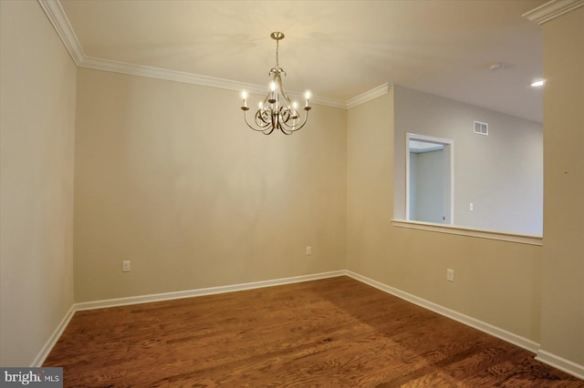 spare room featuring an inviting chandelier, hardwood / wood-style floors, and crown molding