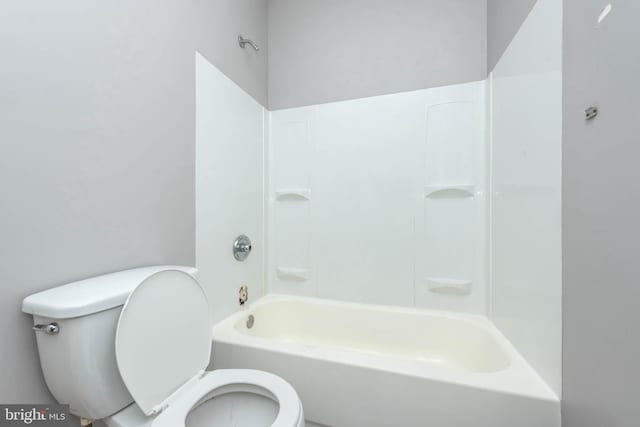 bathroom with toilet and bathing tub / shower combination