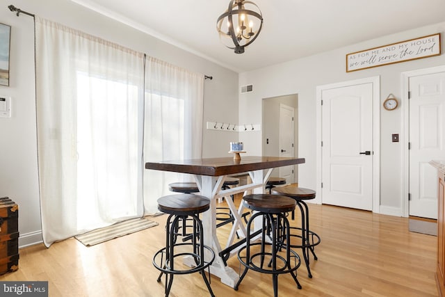 dining room with an inviting chandelier and light hardwood / wood-style floors