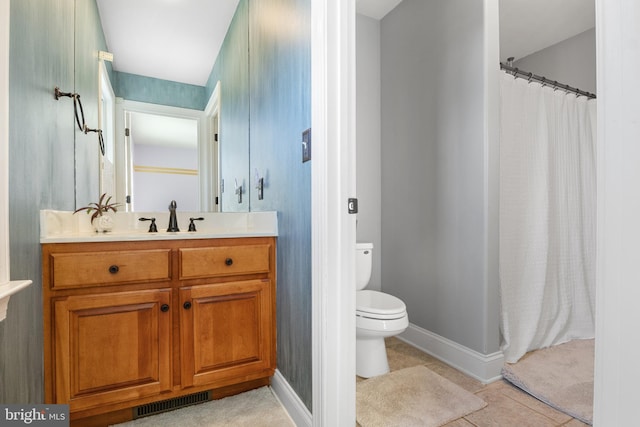 bathroom with tile patterned flooring, vanity, a shower with curtain, and toilet