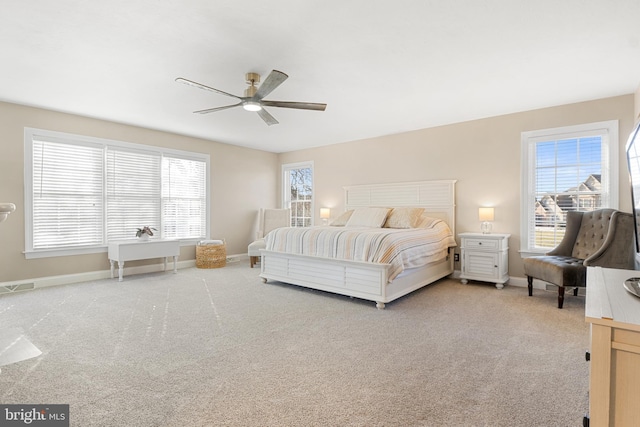 bedroom with multiple windows, carpet, and ceiling fan