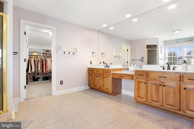 bathroom featuring vanity, a shower with shower door, and tile patterned flooring