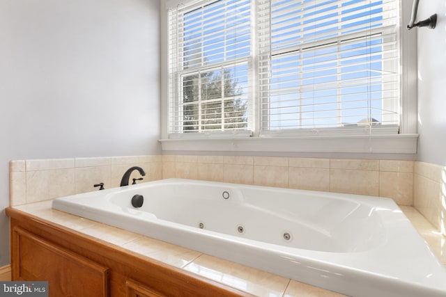 bathroom featuring plenty of natural light and tiled tub