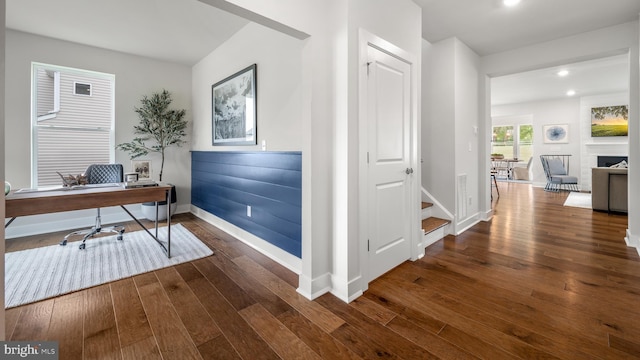 home office with dark hardwood / wood-style flooring