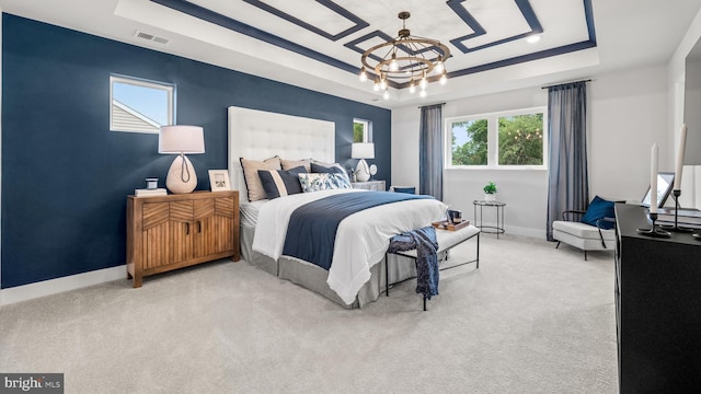 carpeted bedroom featuring a tray ceiling