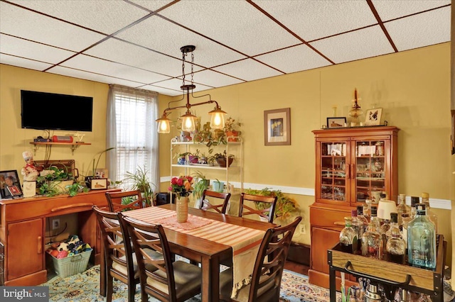 dining area with a drop ceiling