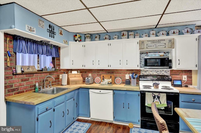 kitchen with sink, dishwasher, range with electric cooktop, white cabinets, and a drop ceiling