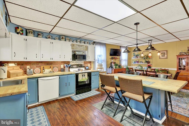 kitchen with blue cabinetry, decorative light fixtures, electric range, dishwasher, and white cabinets