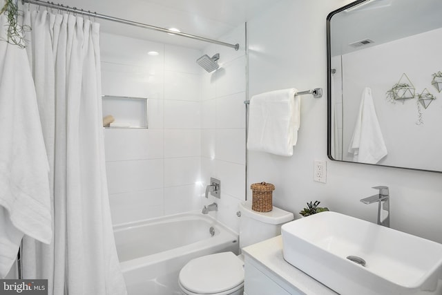 full bathroom with vanity, shower / bath combo, and toilet