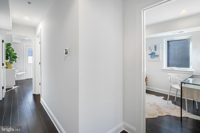 hallway with dark hardwood / wood-style floors