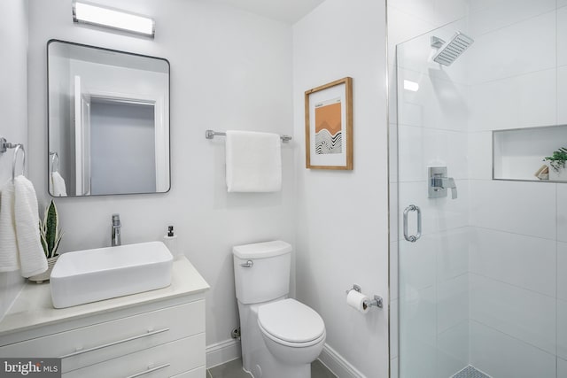 bathroom with vanity, toilet, and walk in shower