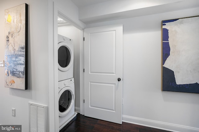 washroom with stacked washer / drying machine and dark hardwood / wood-style floors