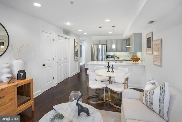 living room with dark hardwood / wood-style flooring and sink