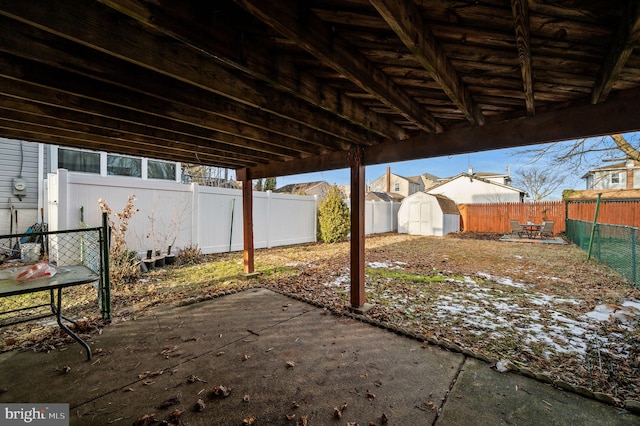 view of patio with a storage shed