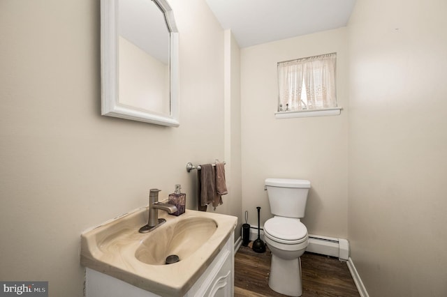 bathroom with vanity, a baseboard radiator, toilet, and wood-type flooring