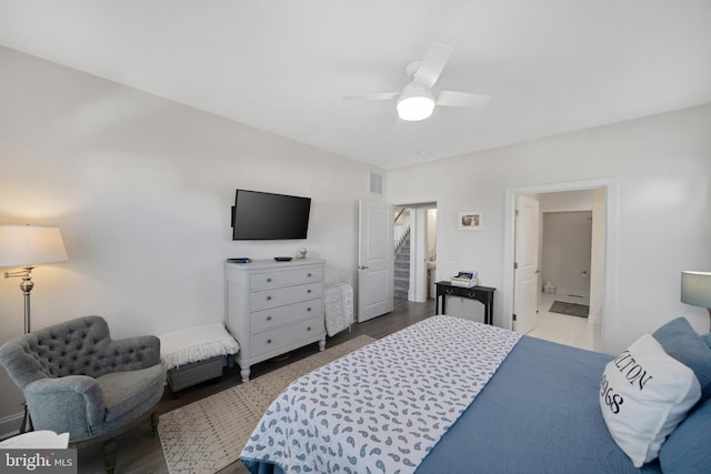 bedroom featuring ceiling fan, ensuite bath, and light hardwood / wood-style flooring