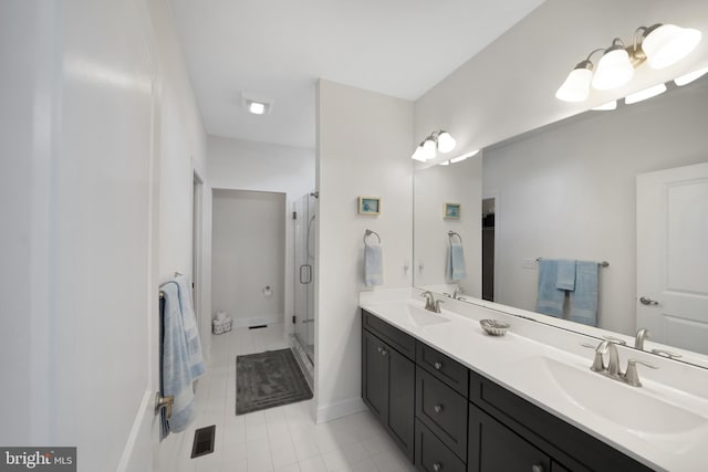 bathroom featuring vanity and a shower with door