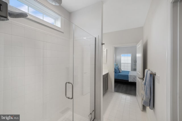 bathroom with a shower with shower door and tile patterned flooring