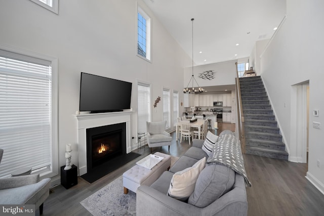 living room with dark hardwood / wood-style floors and a chandelier