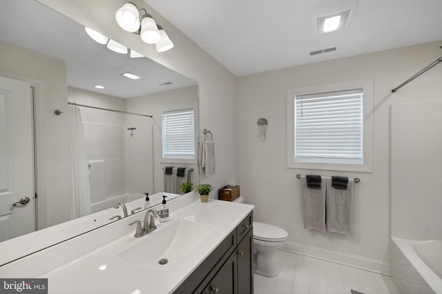 bathroom with vanity, toilet, and a wealth of natural light