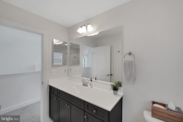 bathroom featuring vanity and toilet