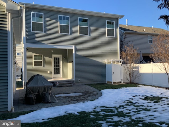 view of snow covered rear of property