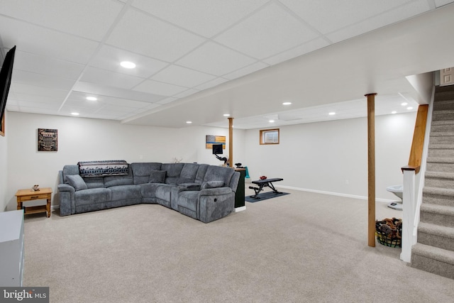 carpeted living room with a drop ceiling