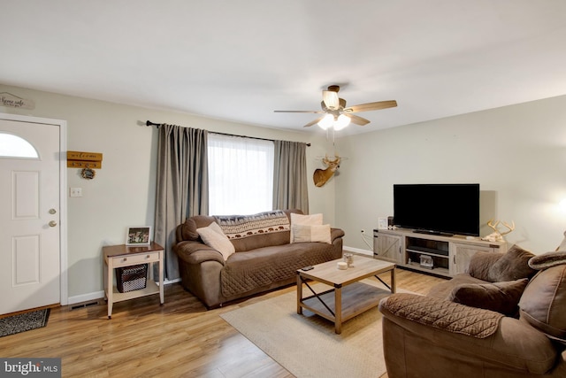 living room with ceiling fan and light hardwood / wood-style floors