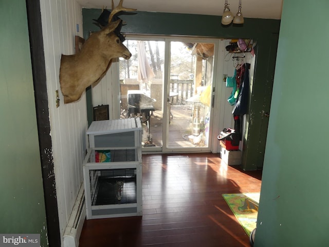 doorway to outside with hardwood / wood-style flooring and a baseboard radiator