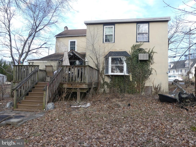 back of property featuring a wooden deck and an AC wall unit