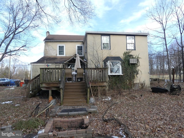 rear view of property with a wooden deck