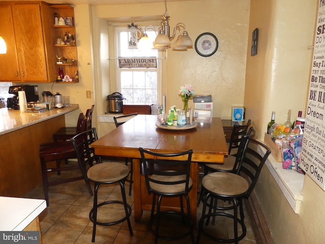 dining area featuring dark tile patterned floors