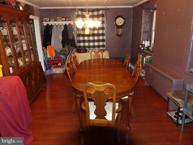 dining space featuring ornamental molding, dark hardwood / wood-style floors, radiator heating unit, and a chandelier