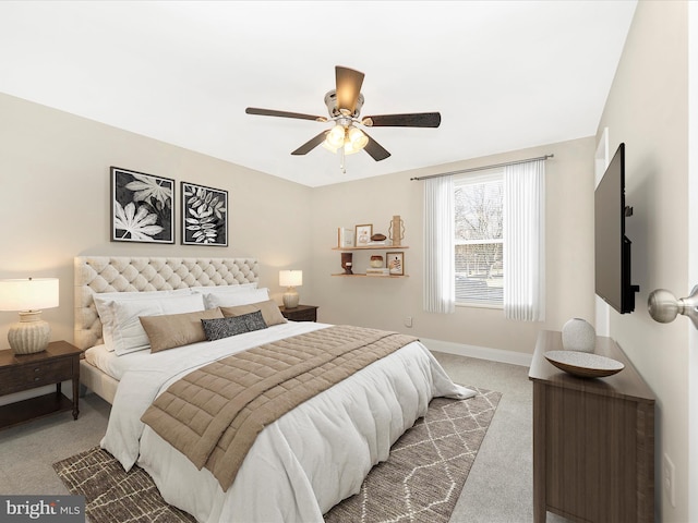 bedroom with ceiling fan, baseboards, and carpet flooring