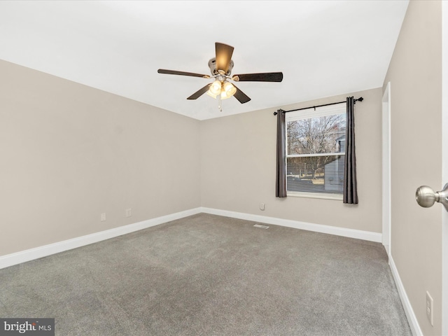 carpeted empty room with ceiling fan and baseboards