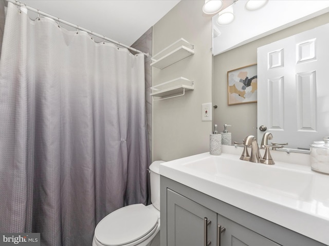 full bathroom with toilet and vanity