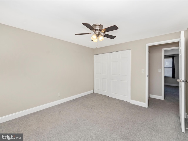 unfurnished bedroom featuring baseboards, a closet, and carpet flooring