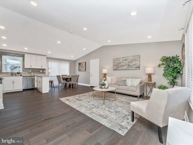 living area with lofted ceiling, baseboards, dark wood finished floors, and recessed lighting