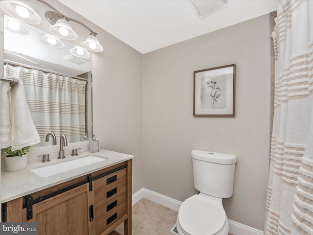 bathroom with visible vents, baseboards, vanity, and toilet