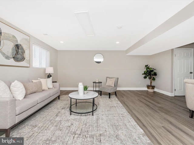 living area featuring recessed lighting, baseboards, and wood finished floors